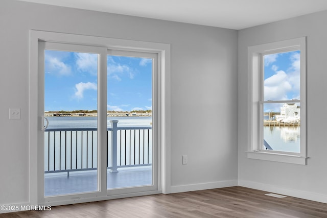 231 Cedar Island Dr, Brick, NJ 08723 - unfurnished room with wood finished floors, a water view, and baseboards