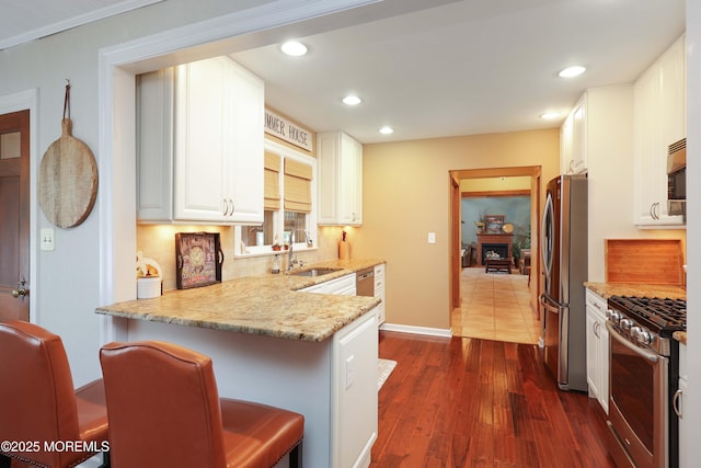 146 Morningside Ave, Union Beach, NJ 07735 - kitchen with stainless steel appliances, a sink, light stone countertops, dark wood-style flooring, and white cabinets