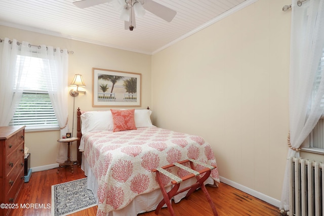 146 Morningside Ave, Union Beach, NJ 07735 - bedroom featuring radiator, baseboards, wood finished floors, ornamental molding, and a ceiling fan