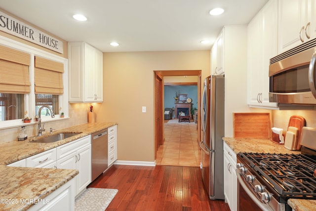 146 Morningside Ave, Union Beach, NJ 07735 - kitchen with a sink, appliances with stainless steel finishes, light stone counters, white cabinets, and decorative backsplash