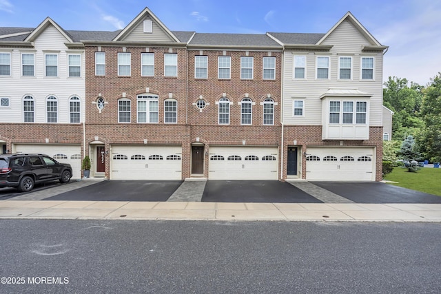 52 Pate Dr, Middletown, NJ 07748 - view of property with brick siding, driveway, and a garage