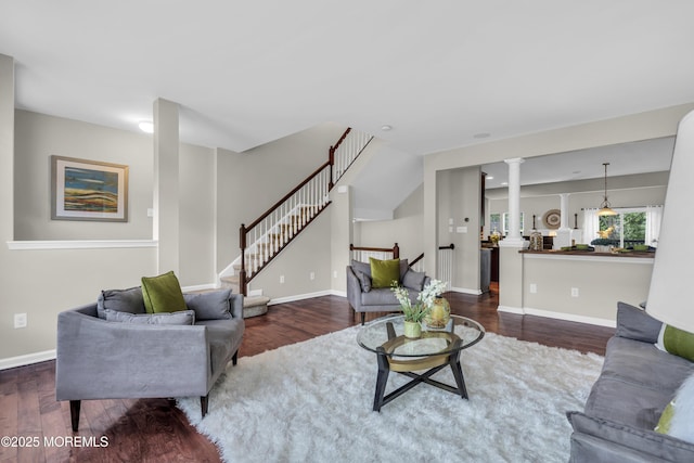 52 Pate Dr, Middletown, NJ 07748 - living area with dark wood-type flooring, stairs, baseboards, and decorative columns