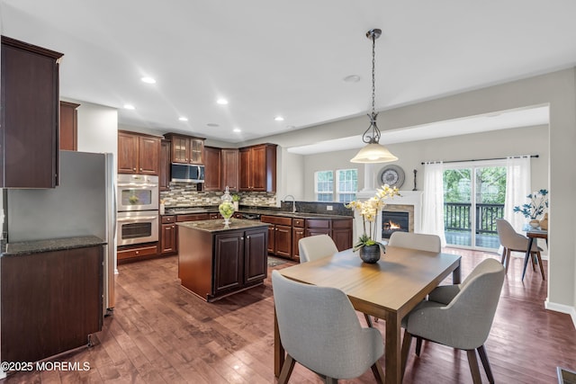 52 Pate Dr, Middletown, NJ 07748 - dining space with dark wood-style flooring, recessed lighting, and a glass covered fireplace