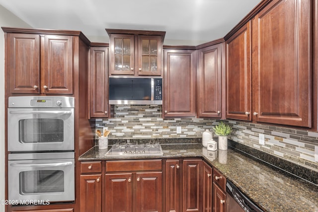 52 Pate Dr, Middletown, NJ 07748 - kitchen featuring appliances with stainless steel finishes, decorative backsplash, dark stone counters, and glass insert cabinets