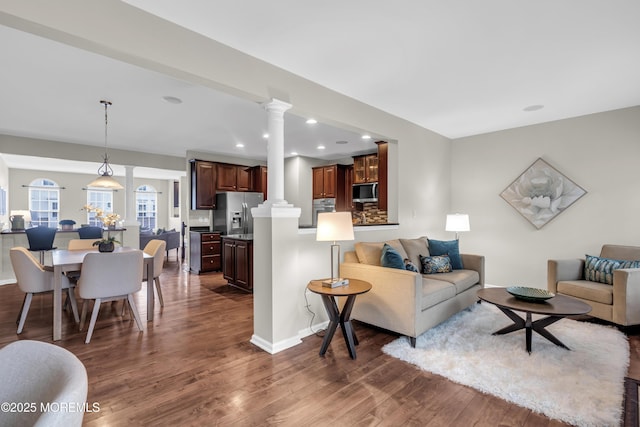52 Pate Dr, Middletown, NJ 07748 - living room with dark wood-type flooring, ornate columns, recessed lighting, and baseboards