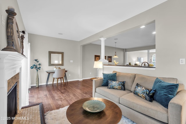 52 Pate Dr, Middletown, NJ 07748 - living area featuring wood finished floors, a tiled fireplace, and baseboards
