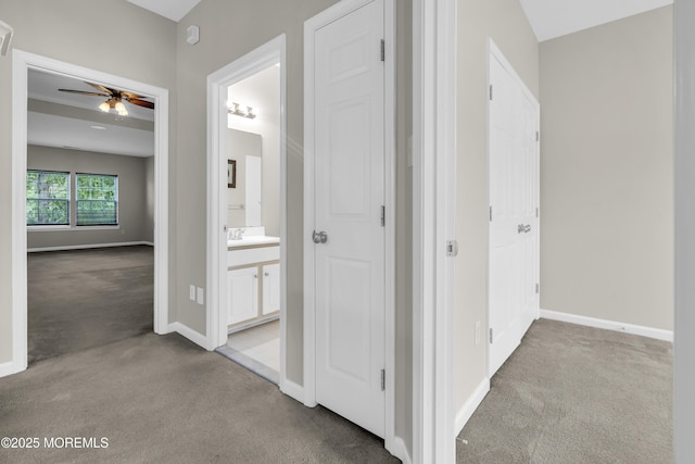 52 Pate Dr, Middletown, NJ 07748 - hallway featuring carpet, baseboards, and a sink