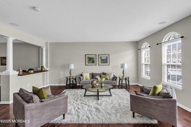 52 Pate Dr, Middletown, NJ 07748 - living room with ornate columns, dark wood finished floors, and baseboards