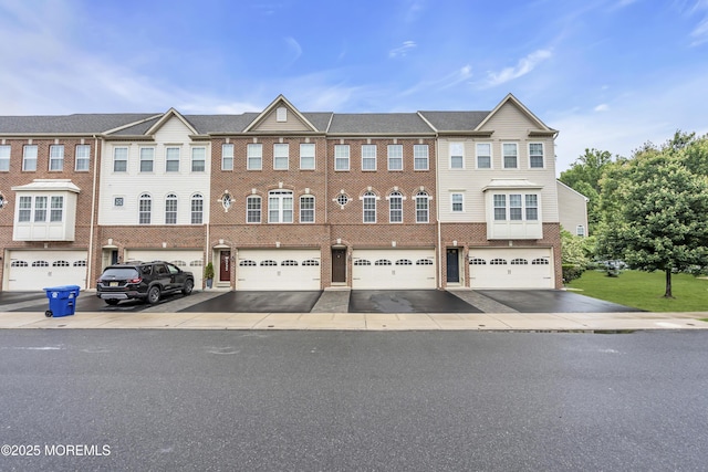 52 Pate Dr, Middletown, NJ 07748 - view of front of house featuring a garage, driveway, and brick siding