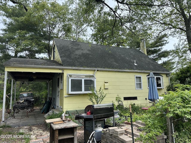 1211 Cedar Bridge Ave, Brick, NJ 08723 - back of house featuring a shingled roof, a patio, and a chimney