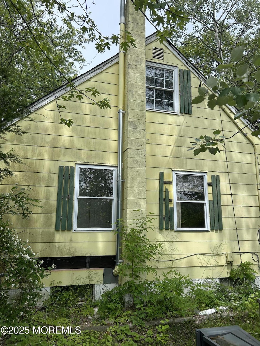 1211 Cedar Bridge Ave, Brick, NJ 08723 - view of home's exterior featuring a chimney