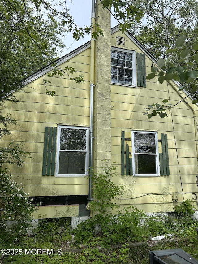 1211 Cedar Bridge Ave, Brick, NJ 08723 - view of home's exterior featuring a chimney