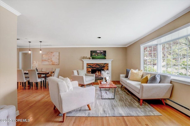 635 Susan Ln, Brielle, NJ 08730 - living room featuring baseboard heating, wood finished floors, ornamental molding, and a fireplace