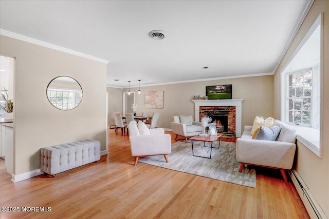 635 Susan Ln, Brielle, NJ 08730 - living room featuring baseboard heating, wood finished floors, healthy amount of natural light, a brick fireplace, and ornamental molding