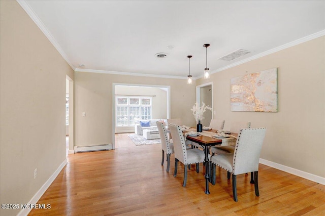 635 Susan Ln, Brielle, NJ 08730 - dining room with baseboard heating, crown molding, light wood-type flooring, and baseboards