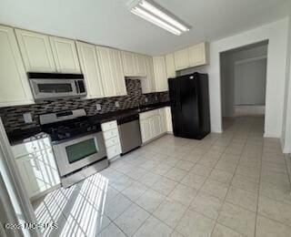 284 Brookfield Dr, Jackson, NJ 08527 - kitchen featuring stainless steel appliances, tasteful backsplash, cream cabinets, and light tile patterned flooring