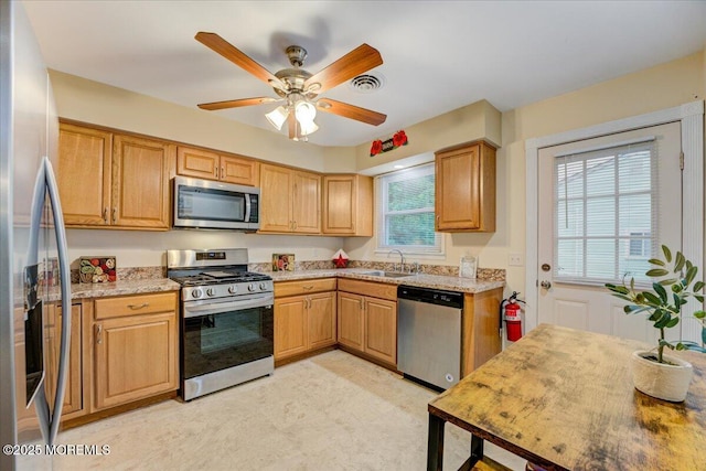 2B Greenwood Ln Unit 62, Whiting, NJ 08759 - kitchen featuring appliances with stainless steel finishes, a sink, a ceiling fan, light floors, and light stone counters