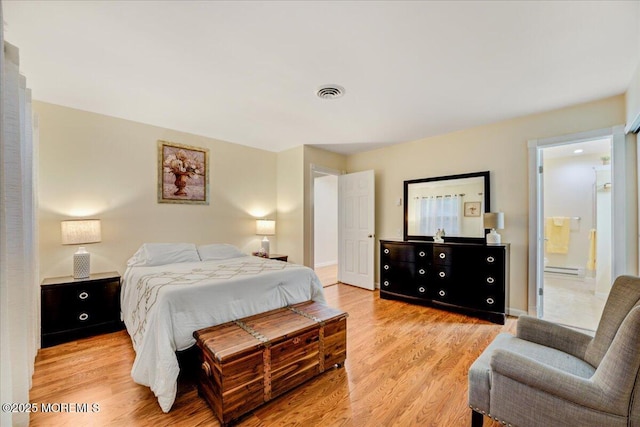 2B Greenwood Ln Unit 62, Whiting, NJ 08759 - bedroom featuring light wood finished floors, connected bathroom, and a baseboard heating unit