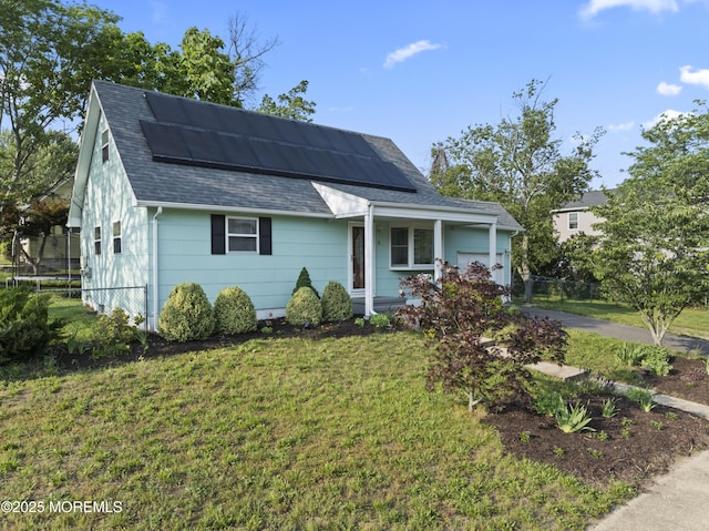 11 Bryant Dr, Jackson, NJ 08527 - view of front of property with a shingled roof, a garage, solar panels, and a front lawn