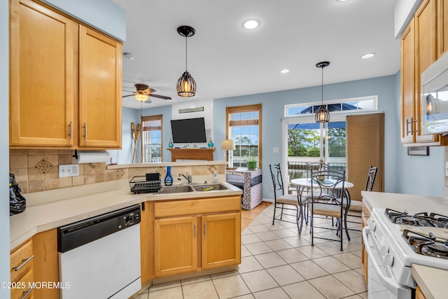 18 Skimmer Ln Unit 53, Bayville, NJ 08721 - kitchen featuring white appliances, a peninsula, a sink, ceiling fan, and backsplash