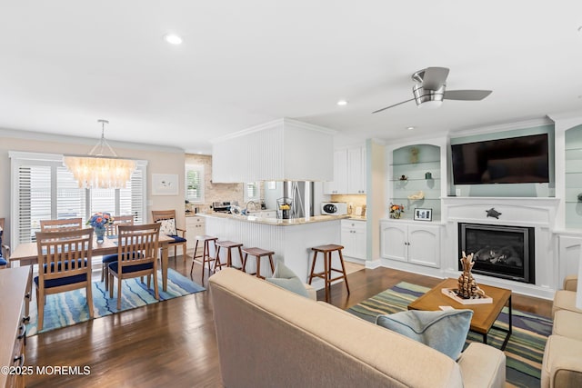 3206 Chicopee Pl, Point Pleasant, NJ 08742 - living room with dark wood-style floors, a chandelier, ceiling fan, ornamental molding, and recessed lighting