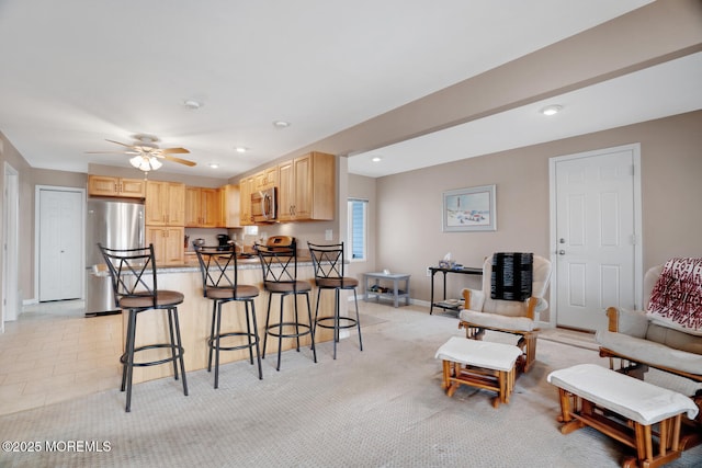 13 Lake Superior Dr, Little Egg Harbor, NJ 08087 - kitchen featuring stainless steel appliances, light brown cabinets, a breakfast bar, ceiling fan, and baseboards