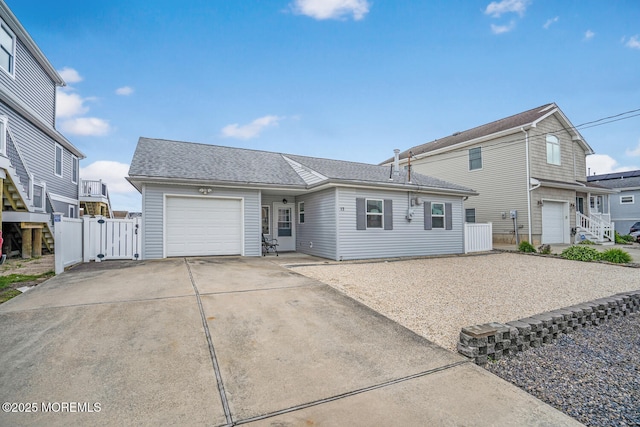 13 Lake Superior Dr, Little Egg Harbor, NJ 08087 - view of front of home with concrete driveway, a garage, a gate, and a shingled roof