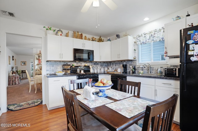 218 Mohican Ln, Little Egg Harbor, NJ 08087 - kitchen featuring black appliances, dark countertops, white cabinets, a sink, and recessed lighting
