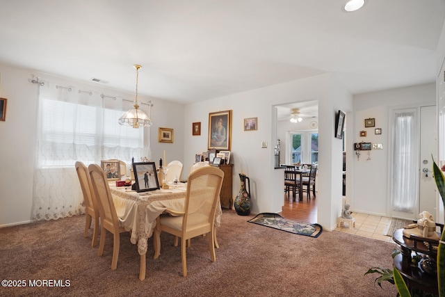 218 Mohican Ln, Little Egg Harbor, NJ 08087 - dining space with light carpet, a chandelier, and a ceiling fan