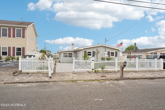927 Beach Haven W Blvd, Manahawkin, NJ 08050 - view of front of home with a fenced front yard and a chimney