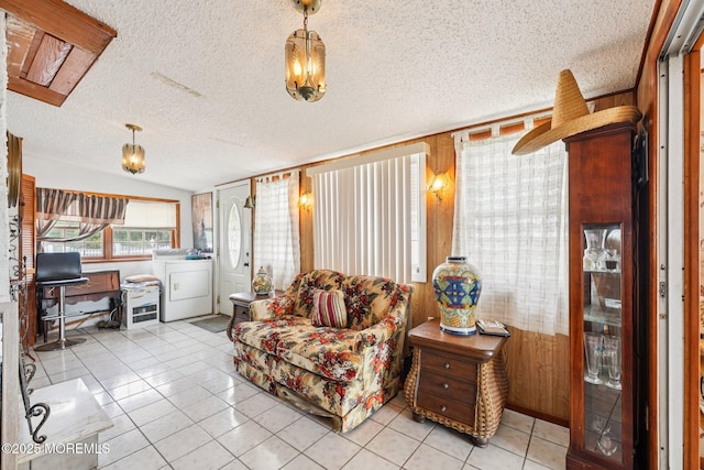 927 Beach Haven W Blvd, Manahawkin, NJ 08050 - living room featuring a textured ceiling, washer and clothes dryer, tile patterned flooring, and wood walls