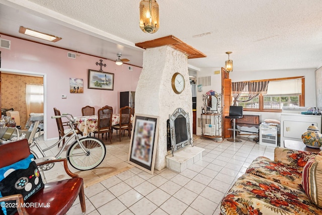 927 Beach Haven W Blvd, Manahawkin, NJ 08050 - living room featuring a textured ceiling, light tile patterned floors, a fireplace, and ceiling fan