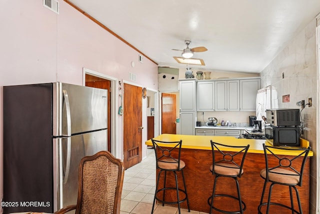 927 Beach Haven W Blvd, Manahawkin, NJ 08050 - kitchen with freestanding refrigerator, lofted ceiling, a ceiling fan, a peninsula, and light countertops