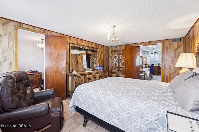 927 Beach Haven W Blvd, Manahawkin, NJ 08050 - bedroom featuring a chandelier, wooden walls, a textured ceiling, and light tile patterned flooring