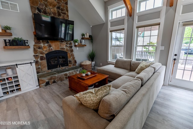 540 Vaughn Ave, Forked River, NJ 08731 - living area featuring light wood-style floors, a stone fireplace, and high vaulted ceiling