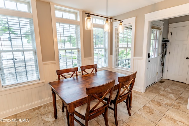 540 Vaughn Ave, Forked River, NJ 08731 - dining space featuring a wainscoted wall, plenty of natural light, a decorative wall, light tile patterned flooring, and baseboards