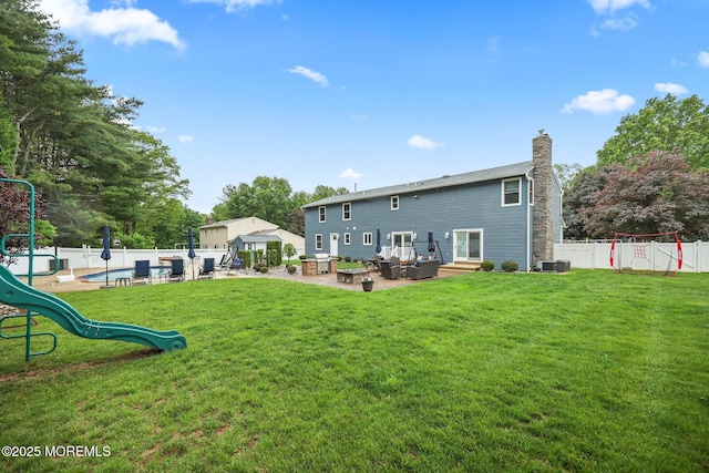41 Revere Pl, Freehold, NJ 07728 - back of property featuring a playground, a patio, a chimney, and central AC