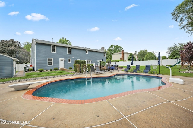 41 Revere Pl, Freehold, NJ 07728 - view of pool with a patio area, a diving board, and a playground