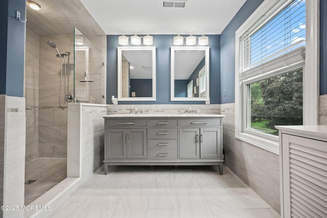 41 Revere Pl, Freehold, NJ 07728 - bathroom with tile walls, double vanity, a walk in shower, marble finish floors, and a wainscoted wall