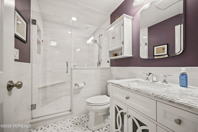 41 Revere Pl, Freehold, NJ 07728 - bathroom with tile walls, vanity, a stall shower, toilet, and wainscoting