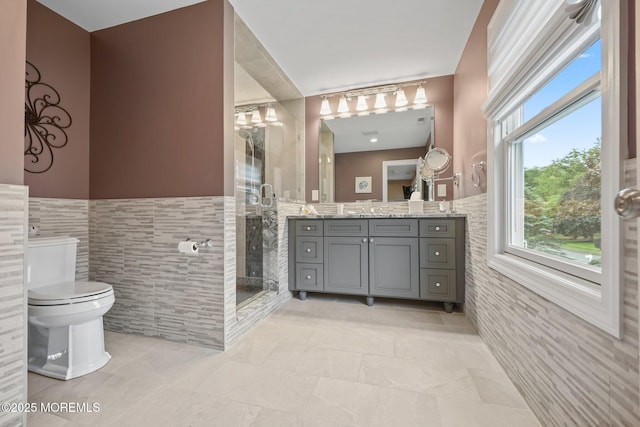 41 Revere Pl, Freehold, NJ 07728 - bathroom featuring tile walls, vanity, a stall shower, a wainscoted wall, and toilet