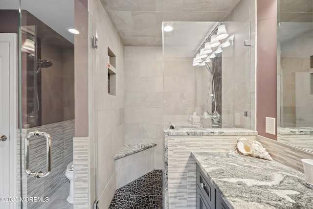 41 Revere Pl, Freehold, NJ 07728 - full bathroom featuring a shower stall, vanity, toilet, and tile walls