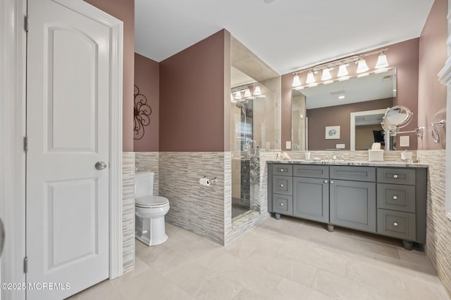 41 Revere Pl, Freehold, NJ 07728 - bathroom with tile walls, toilet, vanity, a stall shower, and a wainscoted wall