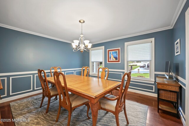 41 Revere Pl, Freehold, NJ 07728 - dining area featuring a chandelier, crown molding, dark wood finished floors, and wainscoting