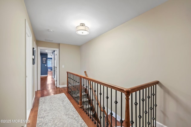 41 Revere Pl, Freehold, NJ 07728 - hall with wood finished floors, baseboards, and an upstairs landing