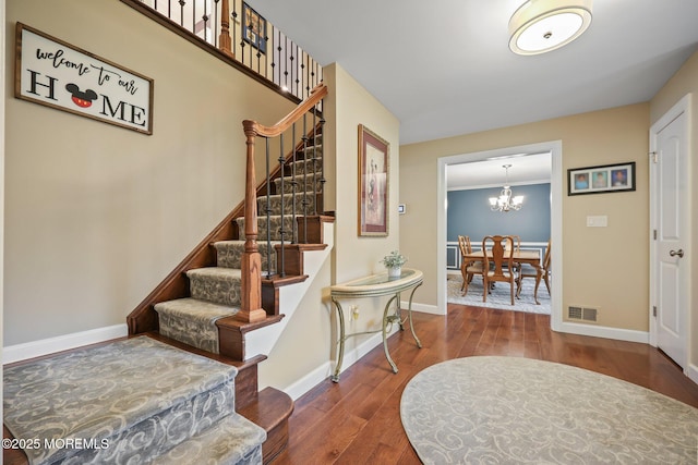 41 Revere Pl, Freehold, NJ 07728 - foyer entrance featuring wood finished floors, stairs, a chandelier, and baseboards