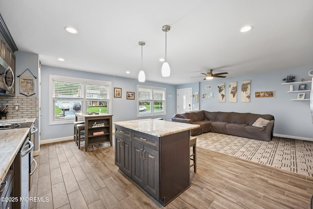 41 Revere Pl, Freehold, NJ 07728 - kitchen featuring light wood-style floors, ceiling fan, a breakfast bar, recessed lighting, and baseboards