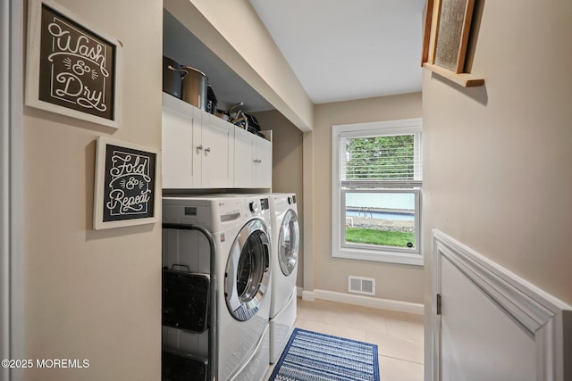 41 Revere Pl, Freehold, NJ 07728 - laundry area with independent washer and dryer, baseboards, light tile patterned floors, and cabinet space