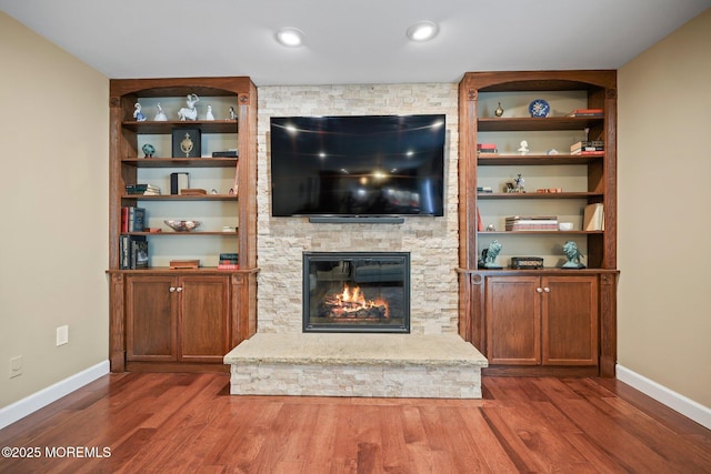 41 Revere Pl, Freehold, NJ 07728 - living area with a stone fireplace, dark wood-type flooring, baseboards, and built in features