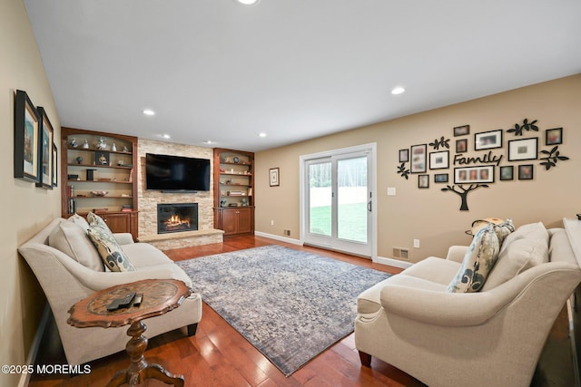 41 Revere Pl, Freehold, NJ 07728 - living room featuring a stone fireplace, wood finished floors, recessed lighting, baseboards, and built in features